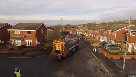 Aerial-View-of-Dustmen-putting-recycling-waste-into-a-waste-truck,-Bin-Men,-Recycling-day,-refuse-collection-in-Stoke-on-Trent,-Staffordshire