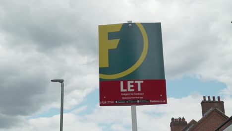 Foxtons-Let-Estate-Agents-Board-in-South-West-london-on-a-summers-day-with-slow-moving-clouds