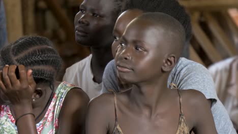 A-close-shot-of-a-group-of-young-African-children-looking-around-a-community-center