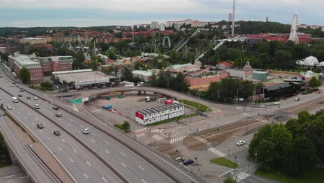 Aerial-view-over-the-amazing-amusement-park-Liseberg,-showing-the-big-european-road-E6-in-the-foreground