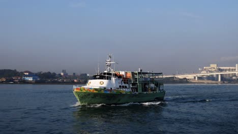 A-small-ferry-sailing-along-Mactan-Channel,-which-separates-Mactan-and-Cebu-islands-in-Central-Visayas,-Philippines