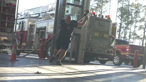 Firefighter-pulls-fire-hose-during-a-firefighting-emergency-training-exercise