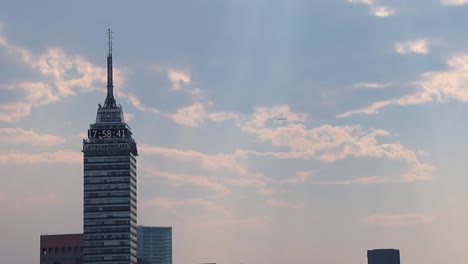 airplane-crossing-behind-latino-americana-tower-in-Mexico-city