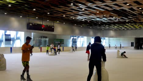 Filipino-families-enjoying-the-ice-skating-facilities-within-the-SM-Seaside-Mall-on-South-Road-Properties,-Cebu-City,-Philippines