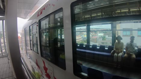 Close-Up-of-Monorail-and-Commuter-Train-Carriages-Arriving-at-Station