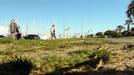 Old-women-walking-in-the-parking-Lot-of-yacht-pier