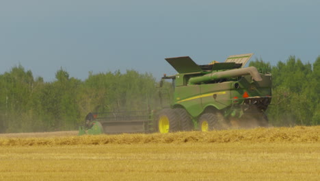 Combine-tractor-harvesting-a-wheat-field-on-a-late-summer-morning