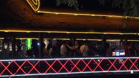 Tourists-Walking-on-an-Illuminated-Bridge