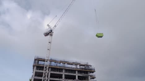 Baukran-Hebt-Einen-6-M-Hohen-Abfallbehälter-Auf-Die-Oberste-Ebene-Der-Baustelle