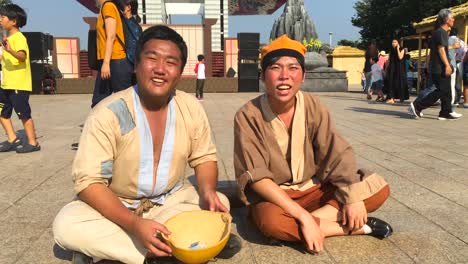 Reenactment-of-street-beggars-at-Hanseong-Baekje-festival,-Olympic-Park,-Oryun-dong,-Songpa-gu,-Seoul,-South-Korea