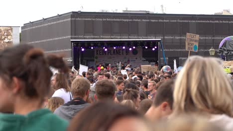 Masses-of-crowds-with-stage-in-distance-during-fridays-for-future-climate-change-protests-in-Vienna,-Austria-SLOW-MOTION