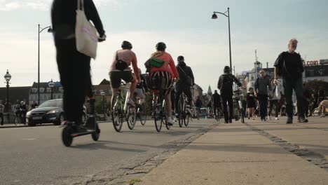 People-riding-bicycle-on-street-of-Copenhagen,-low-angle