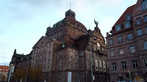 Side-view-of-Nuremberg-opera-from-the-sidwalk-with-the-street-and-cars-in-foreground