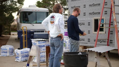 Contractor-and-male-construction-workers-on-a-Los-Angeles-suburban-job-site-building-a-tiny-house