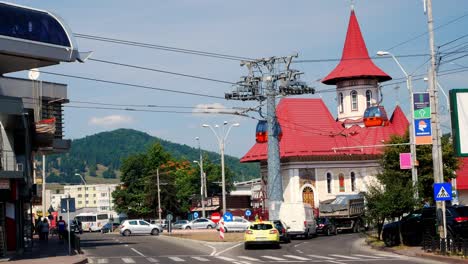 Locked-shot-of-the-"9-May"-Avenue,-the-Descent-of-the-Holy-Spirit-church-and-cable-car-at-Piatra-Neamt,-Romania