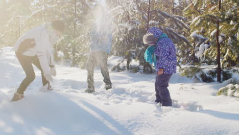 Mother-And-Children-Playing-Around-In-The-Snow