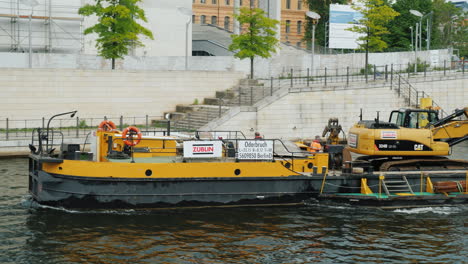Barge-Carrying-An-Excavator-Along-River