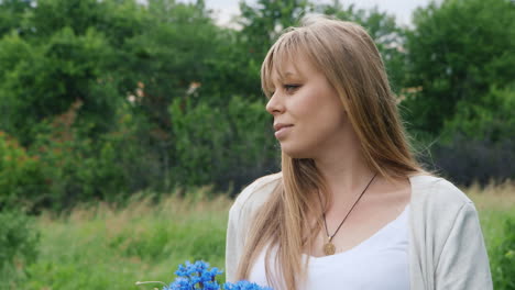 Pregnant-Woman-Holding-Blue-Flowers