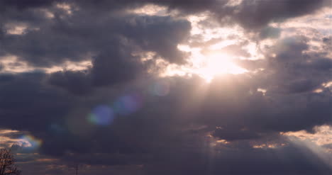 Panning-Shot-Of-Sunlight-Streaming-Through-Clouds-During-Sunset