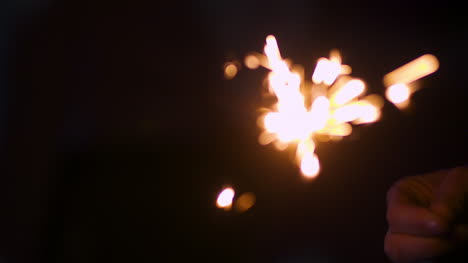 Woman-Holding-Sparklers-In-Hands