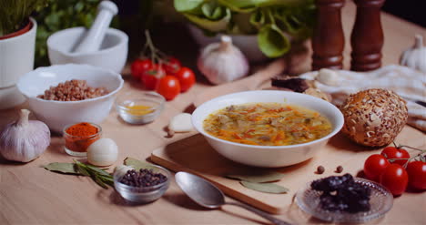 Soup-In-Bowl-Amidst-Various-Ingredients-Assorted-On-Wooden-Table-7