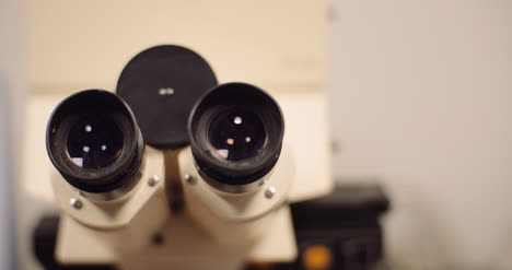 Close-Up-Panning-Shot-Of-Binocular-Optical-Microscope-In-Laboratory