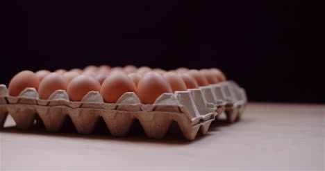 Eggs-Extruder-Full-Of-Fresh-Eggs-On-Black-Background-6