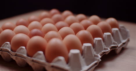 Eggs-Extruder-Full-Of-Fresh-Eggs-On-Black-Background-7