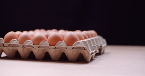 Eggs-Extruder-Full-Of-Fresh-Eggs-On-Black-Background-9