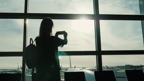 Woman-Taking-Pictures-From-Airport-Terminal