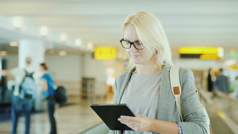 Woman-Using-Tablet-on-Travelator