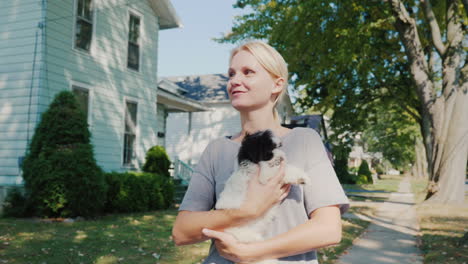 Woman-Walking-A-Puppy-In-Her-Arms