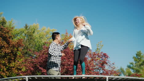 Couple-Have-Fun-on-Trampoline