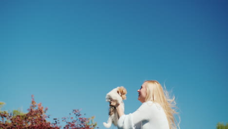 Young-Woman-Holding-Puppy-Jumping