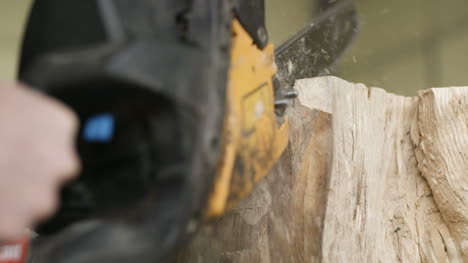 Cutting-Through-Wood-With-Chainsaw-In-Slow-Motion