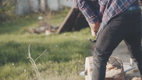 Young-Man-Using-Chainsaw-In-Garden-