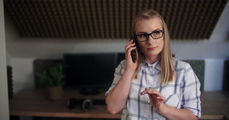 Female-Professional-Using-Smart-Phone-In-Office