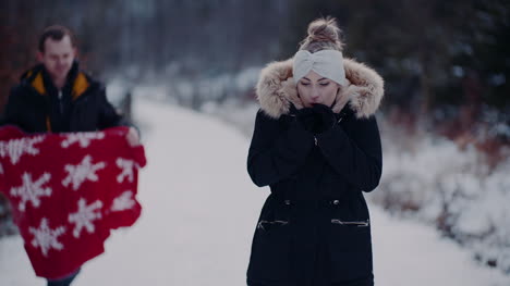 Woman-Giving-Hand-To-Boyfriend-Ona-Walk-In-Forest-In-Winter-1