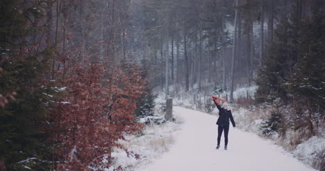 Woman-Moving-Scarf-In-In-Winter-In-Forest
