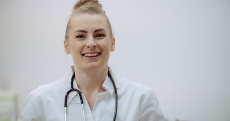 Positive-Doctor-Puts-On-Stethoscope-And-Smile-2