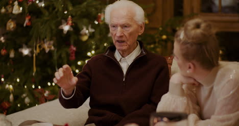 Woman-Talking-With-Grandfather-At-Home-During-Christmas-6