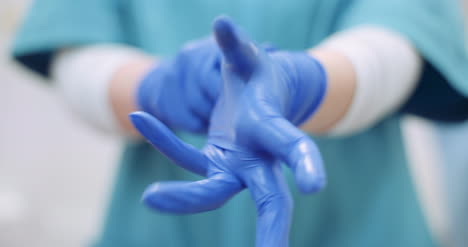 Female-Surgeon-Putting-On-Protective-Gloves-1