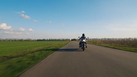Biker-Rides-On-A-Rural-Road-Tractor-Rides-Past-Him-Hd-Video