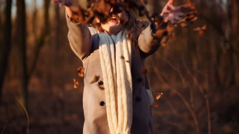 Positive-Happy-Woman-Throwing-Leaves-In-Autumn-In-Park-2