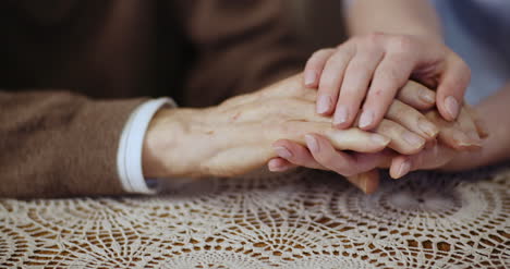 Woman-Comforting-Wrinkled-Old-Hand