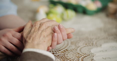 Woman-Comforting-Wrinkled-Old-Hand-2