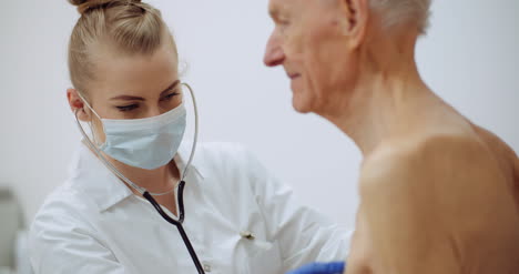 Female-Doctor-Examine-Elderly-Man-With-Stethoscope-2