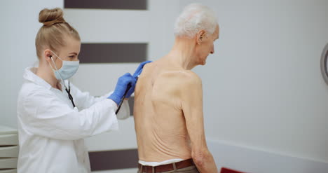 Female-Doctor-Examine-Elderly-Man-With-Stethoscope-4