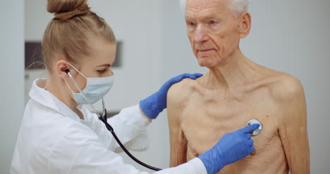 Female-Doctor-Examine-Elderly-Man-With-Stethoscope-5