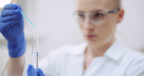 Portrait-Of-Female-Scientist-With-A-Pipette-Analyzes-A-Liquid-To-Extract-The-Dna-In-Lab-3